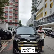 Customer collecting a black Toyota MPV